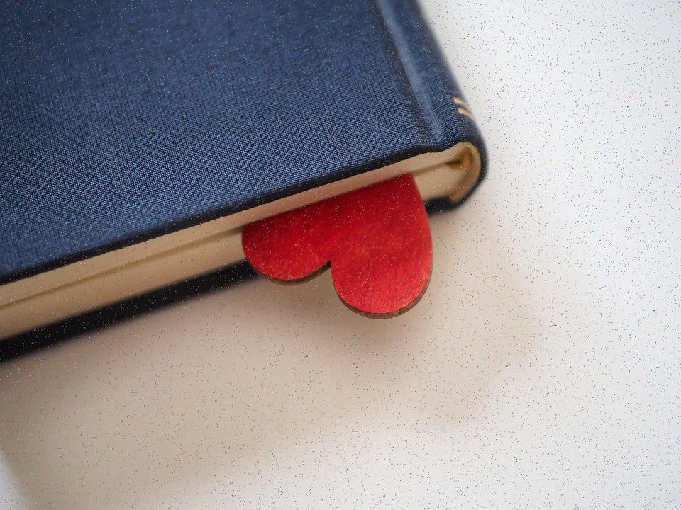 A ribbon bookmark lying across the open pages of a book